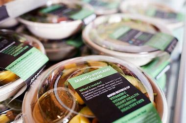 ready meals on shelf with back and green labels